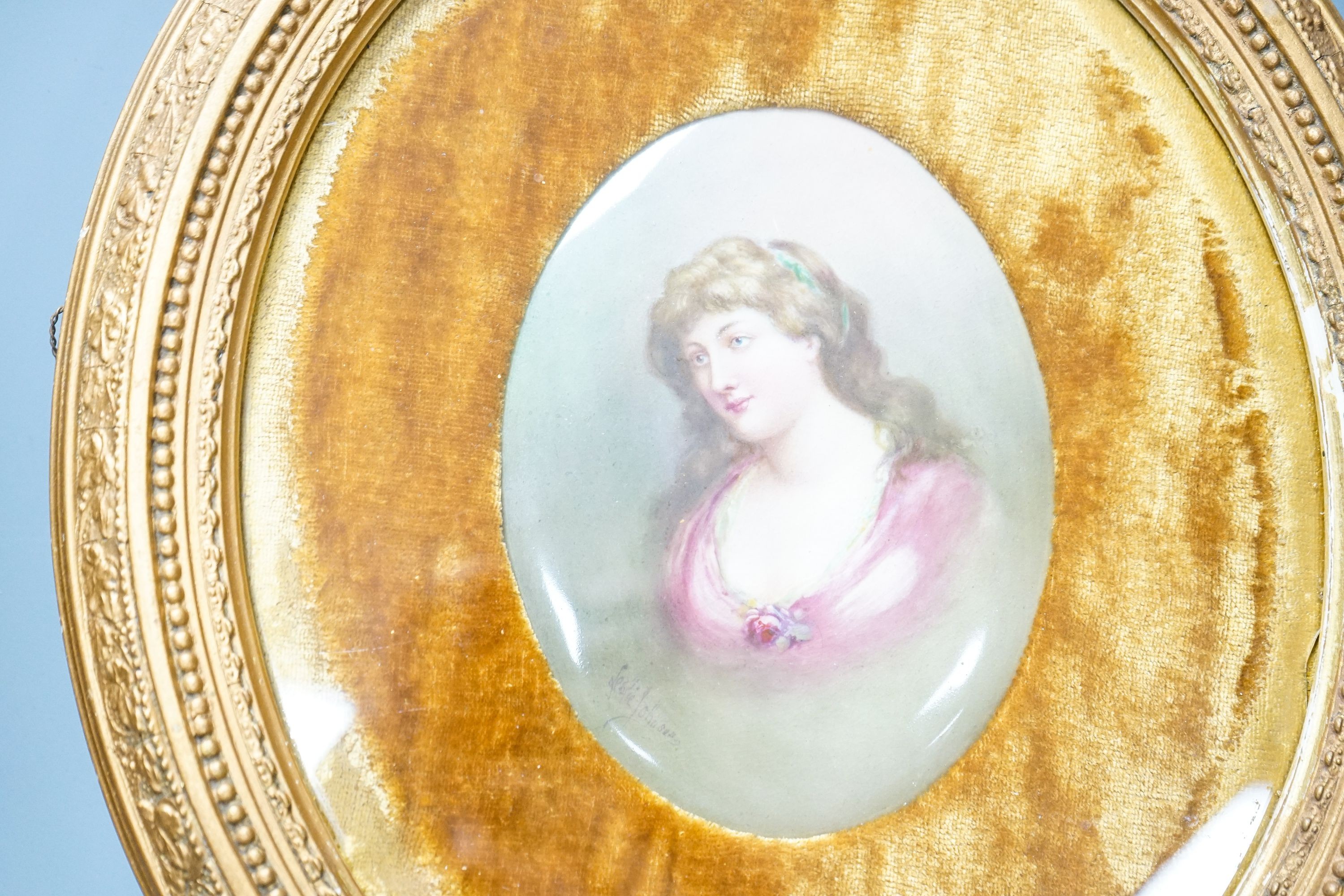 A Royal Doulton oval plaque, signed Leslie Johnson, hand painted with a portrait of a lady, in gesso frame, with velvet mount.